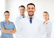 © Syda Productions - smiling male doctor in white coat