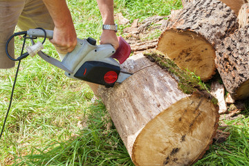 Cutting wood with chain saw