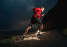 Man Running In The Mountains At Night.