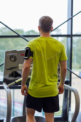 Poster - man exercising on treadmill in gym from back