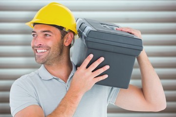 Poster - Composite image of handyman carrying toolbox on shoulder