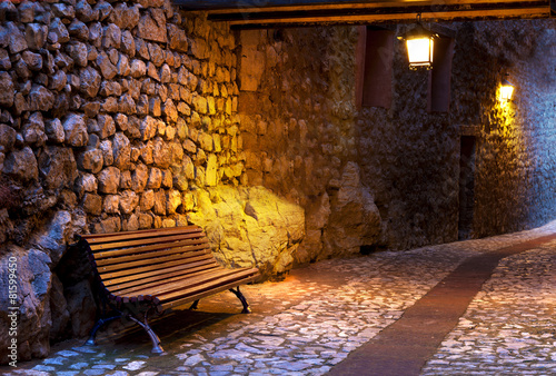 Naklejka na szybę Banco en calle de pueblo iluminado por farolillos