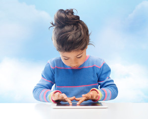 Poster - little girl with tablet pc over sky background