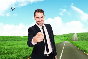 Poster - Composite image of happy businessman pointing at camera