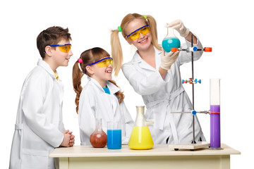teens and teacher of chemistry at lesson making experiments