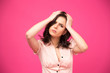 © Drobot Dean - Serious young woman over pink background