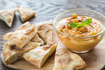 Wall Mural - A bowl of hummus with pita slices