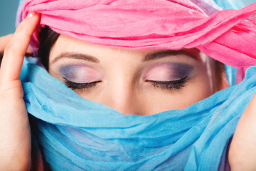 Wall Mural - woman makeup on eyes hiden her face with shawl