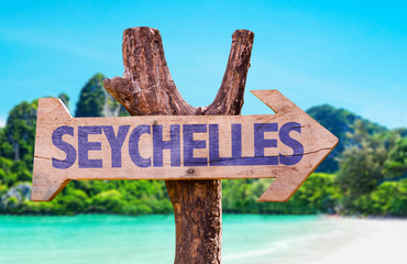 Wall Mural - Seychelles wooden sign with beach background