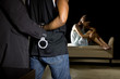 © Innovated Captures - Cop arresting a man for domestic violence