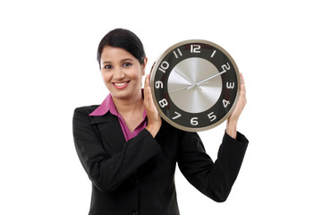 Wall Mural - Young business woman holding clock in hands