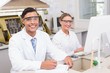 © WavebreakMediaMicro - Smiling scientists looking at camera