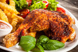 Grilled chicken leg with chips and vegetables