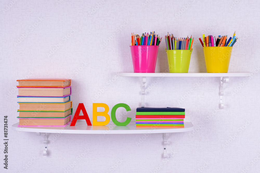 Shelves with stationery in child room close-up