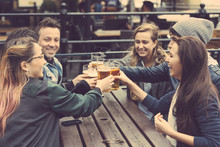 Group Of Friends Enjoying A Beer At Pub In London
