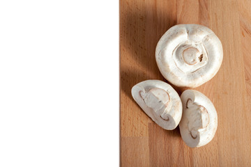 Champignons on a wooden board, white background