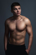 © svitlychnaja - Sexy athletic man over grey background.