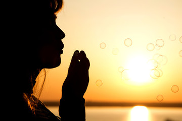 Wall Mural - beautiful young girl blow bubbles on nature