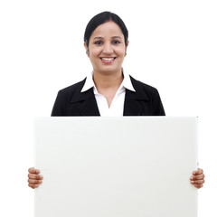 Young happy business woman holding blank signboard