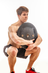 Wall Mural - Awesome young bodybuilder holding weights