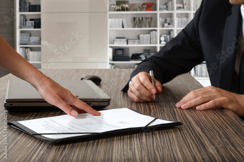 Fotografie, Obraz female hand pointing to businessman at signature place on a cont
