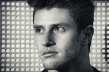 Wall Mural - Headshot of attractive young man looking to a side