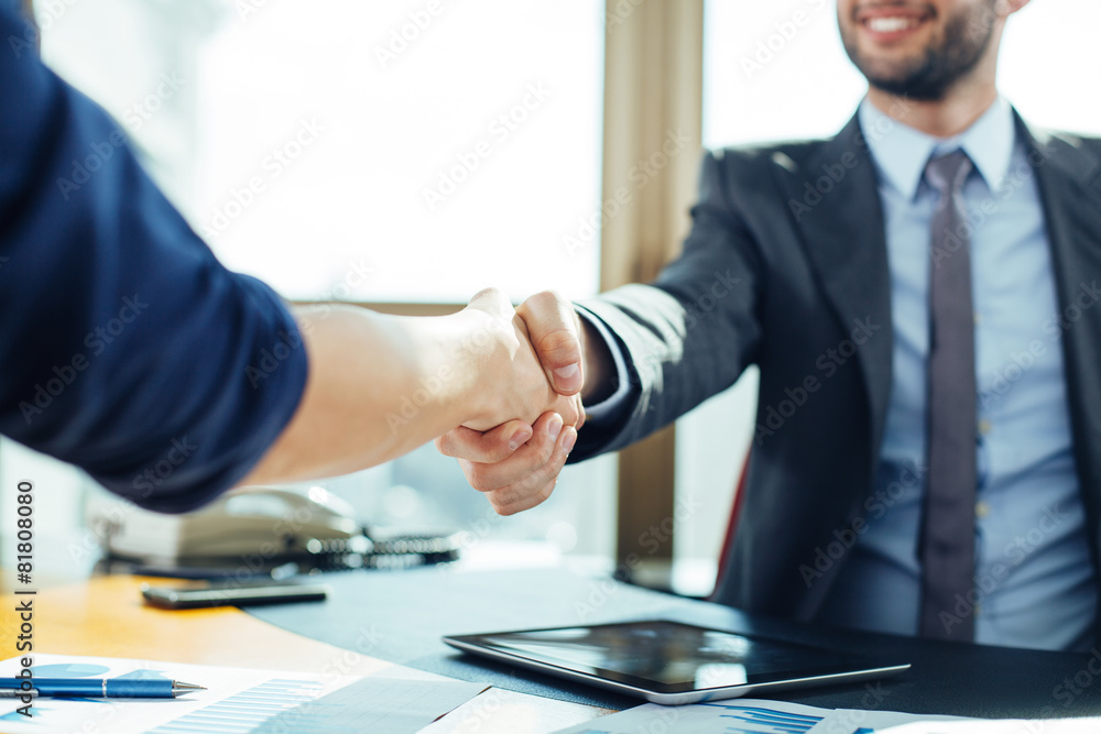 Close up of business handshake in the office - obrazy, fototapety, plakaty 