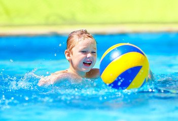 Wall Mural - cute kid playing in water sport games in pool