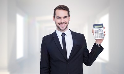 Poster - Composite image of smiling businessman presenting a calculator