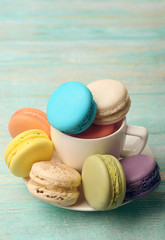 Wall Mural - Tasty colorful macaroons on color wooden background