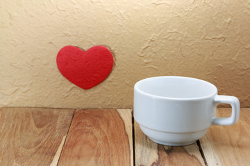 Wall Mural - Coffee cup and red heart on a wall. selective focus, Process col