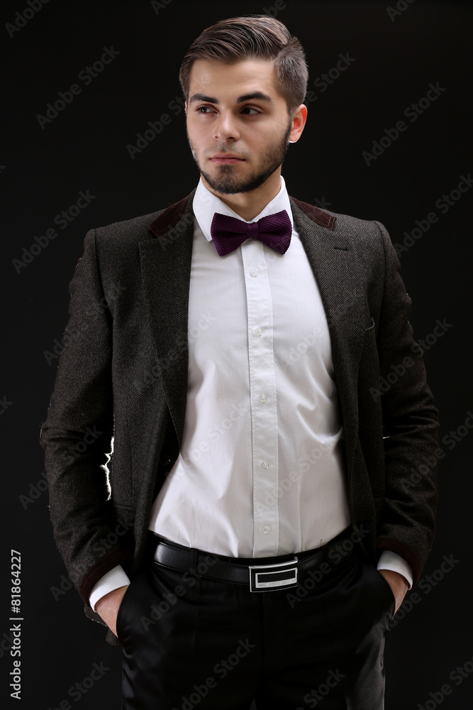 Elegant man in suit on dark background