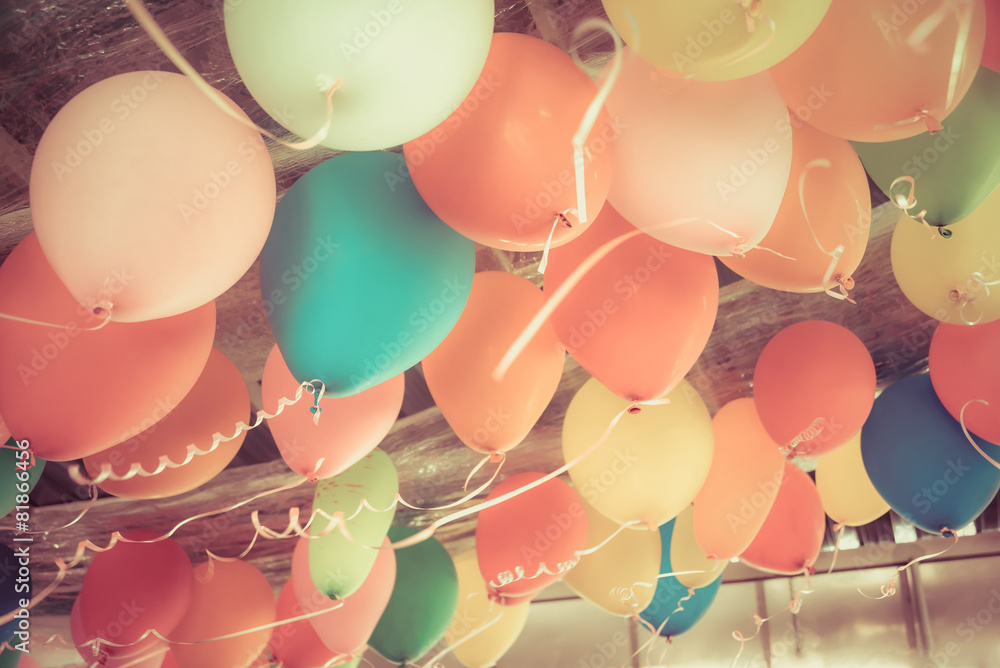 Colorful balloons floating on the ceiling of a party in vintage - obrazy, fototapety, plakaty 