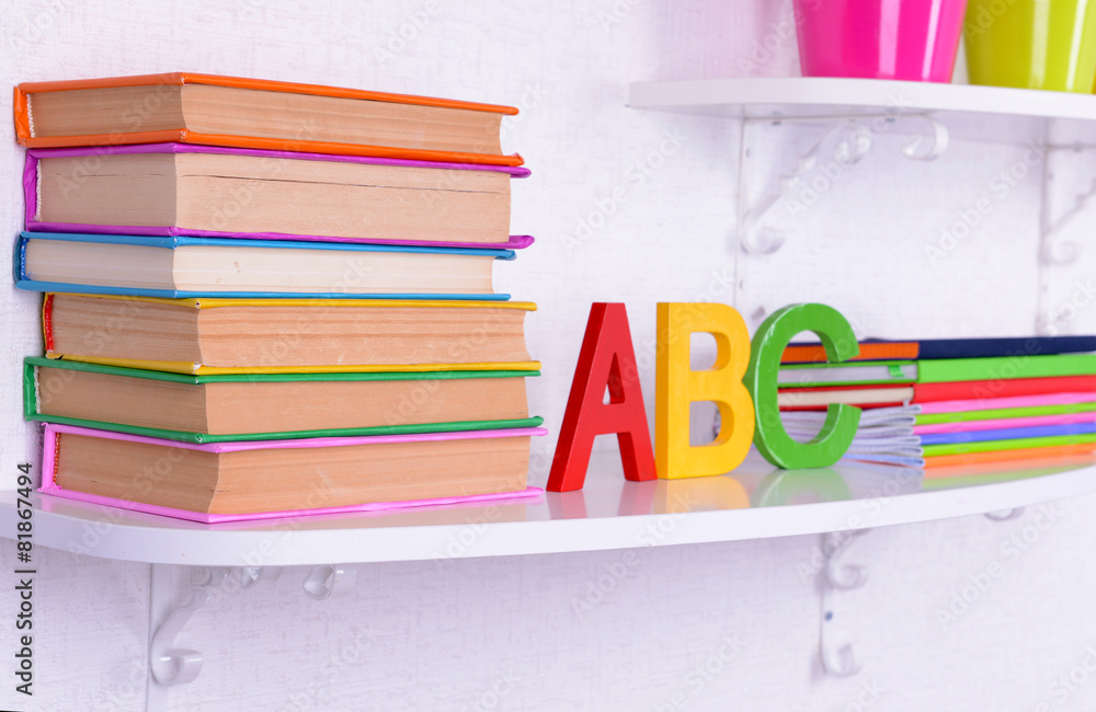 Shelves with stationery in child room close-up