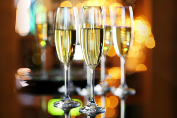 Wall Mural - Glasses of champagne on bar background