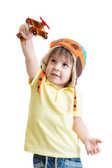 happy kid boy pilot and playing with wooden airplane toy