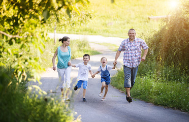 Happy young family spending time together outside in nature