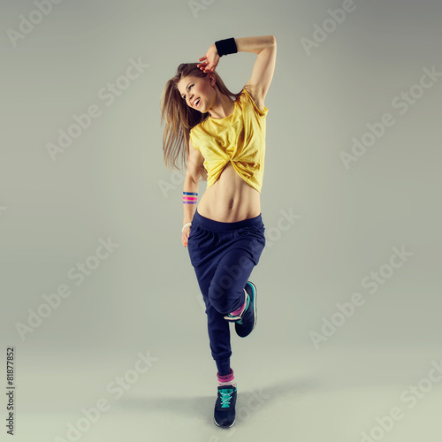Vászonkép Beautiful street dancer showing dancing pose in studio