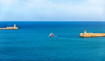 Wall Mural - Boat leaving the port of Valletta - Malta