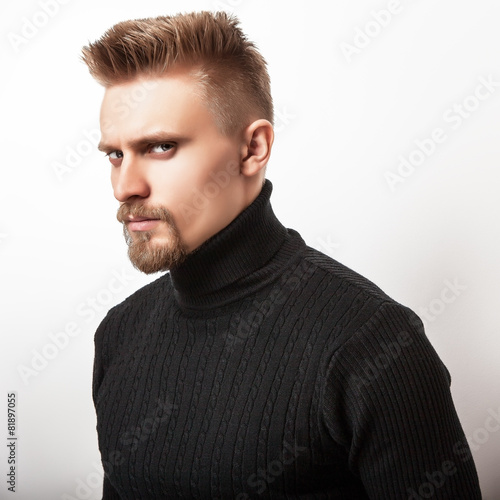 Fototapeta do kuchni Studio portrait of young handsome man in knitted sweater. 