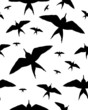 Seamless pattern with black silhouettes of birds on white