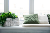Fototapeta  - Pillows on the windowsill and plastic window