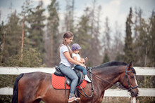 Mom And Child Horseback Riding