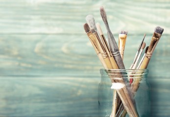 Wall Mural - Paint. Photo of paint brushes in a jar