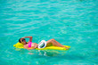 © travnikovstudio - Woman relaxing on inflatable air mattress at turquoise water