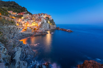 Manarola town on the coast of Ligurian Sea at dusk, Italy