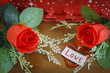Valentines Day with heart and roses on wood background