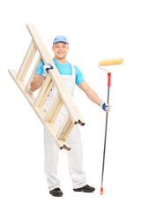 Wall Mural - Young painter holding paint roller and a ladder