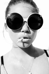  portrait of  sexy woman in sunglasses with cigarette