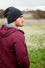 Wall Mural - Handsome guy with beard in the field thinking